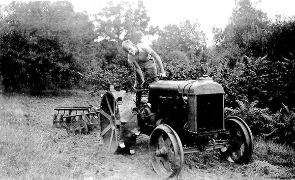 Clarence on the farm tractor 1937